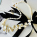 Leoni & Vonk pearl necklace with a white box and black ribbon