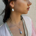 Profile of dark haired girl wearing Leoni & Vonk jewellery