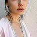 Cropped image of a dark haired girl wearing Leoni & Vonk  pearl necklace