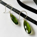 Leoni & Vonk peridot quartz earrings on a white background with Leoni & Vonk ribbon