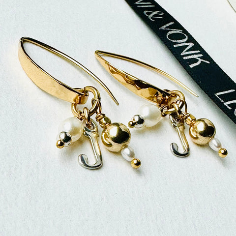 Leoni & Vonk gold personalised charm earrings on a white background with Leoni & Vonk ribbon