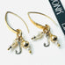 Leoni & Vonk gold personalised charm earrings on a white background with Leoni & Vonk ribbon