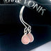 Leoni & Vonk pink opal silver earrings on a black box