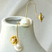 Leoni & Vonk gold flower and pearl earrings on a white vase