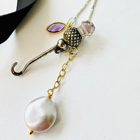 Leoni & Vonk antique sterling silver and amethyst Victorian button hook charm necklace on a white background.