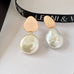 Leoni & Vonk yi Su rose gold and keshi pearl stud earrings on a white background with Leoni & Vonk ribbon