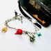 Leoni & Vonk sterling silver charm bracelet with sailboat, shell, anchor, pearl and semi precious stone charms on  awhite background
