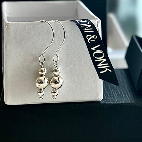 Leoni & Vonk sterling silver ball earrings on a white box and with Leoni & Vonk ribbon