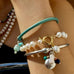 Cropped image showing a womans arm wearing Leoni & Vonk bracelets