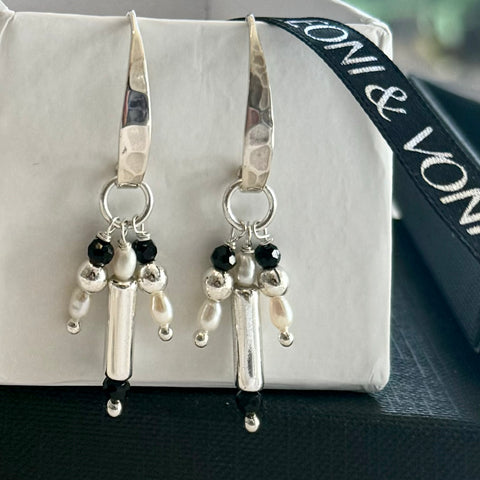 Leoni & Vonk sterling silver charm earrings on a white box and with Leoni & Vonk ribbon