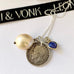 Leoni & Vonk antique 1918 British threepence with a sapphire heart and baroque pearl drop on a sterling silver chain. The necklace is on a white background with Leoni & Vonk ribbon