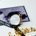 Leoni & Vonk victorian rolled gold photo locket on a vintage postcard and Leoni & Vonk ribbon