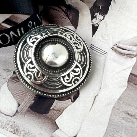 Leoni & Vonk vintage silver celtic brooch on a vintage image.