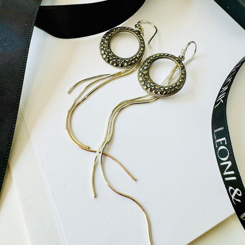 Leoni & Vonk sterling silver marcasite earrings on a white background with Leoni  & Vonk ribbon