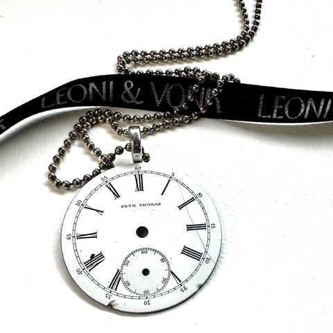 Leoni & Vonk vintage watch face necklace on a white background