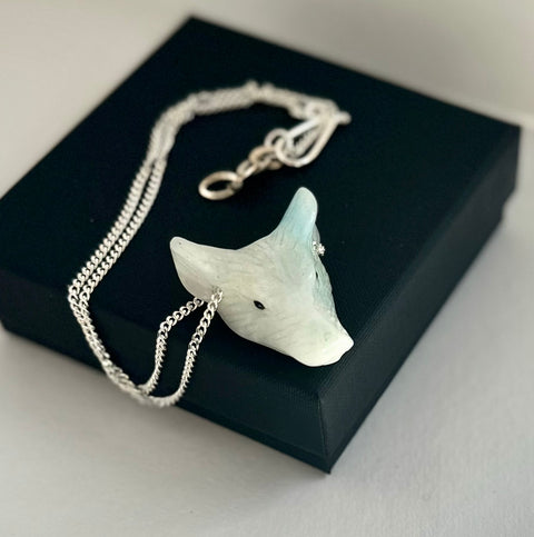 Leoni & Vonk wolf head necklace on a black box