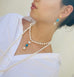 Dark haired girl wearing Leoni & Vonk turquoise and pearl jewellery