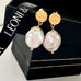 Leoni & Vonk keshi pearl and gold stud earrings on a Leoni & Vonk gift box and with Leoni & Vonk ribbon