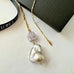 Leoni & Vonk Venetian bead and baroque pearl necklace on a white background with Leoni & Vonk ribbon