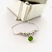 Leoni & Vonk sterling silver and peridot friendship bracelet  on a white box
