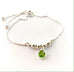 Leoni & Vonk sterling silver and peridot friendship bracelet  on a white background