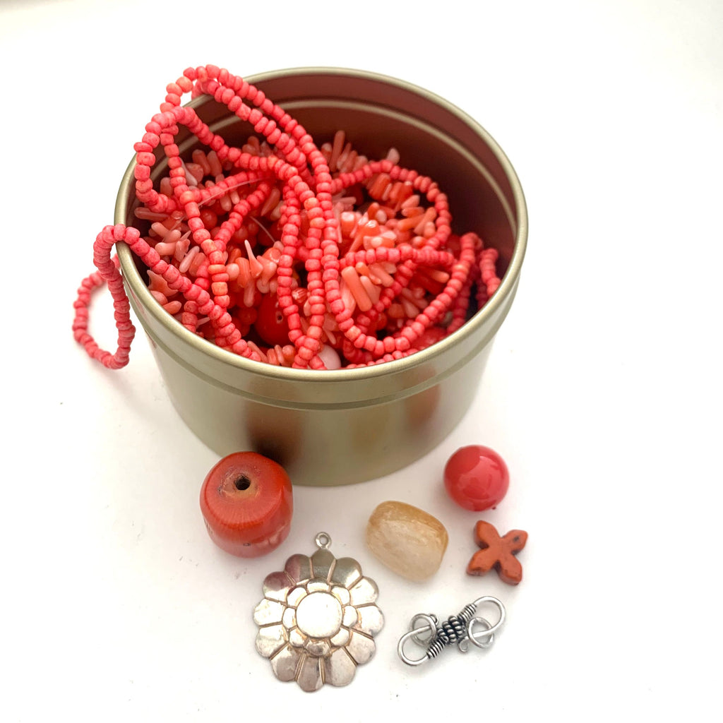 Leoni & Vonk coral bead tin with a variety of beads in different shapes and sizes.
