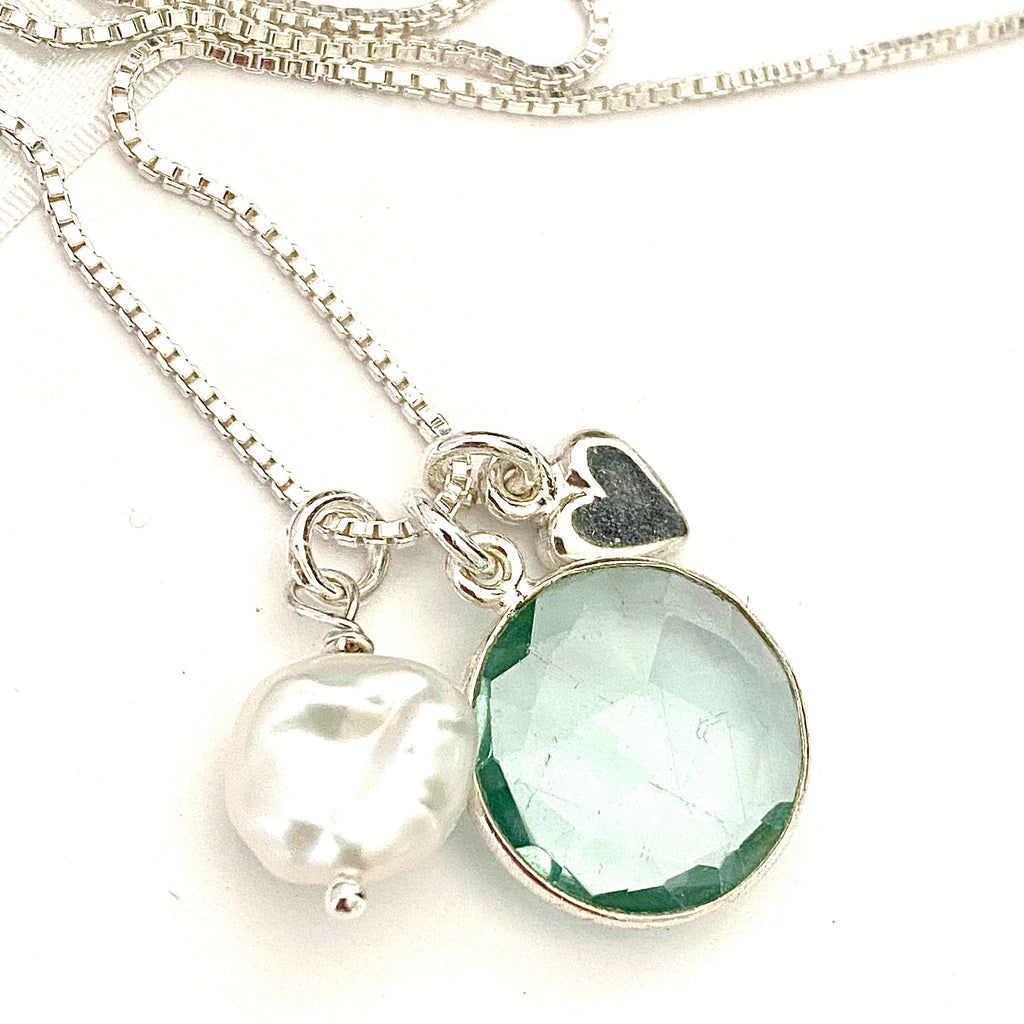 Leoni & Vonk March birthstone aquamarine pearl and heart necklace on a white background