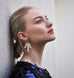 Model wearing Leoni & Vonk statement pearl earrings and a blue Zara sequin dress