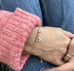 Model wearing pink jumper, jeans and Leoni & Vonk personalised sterling silver friendship bracelet 