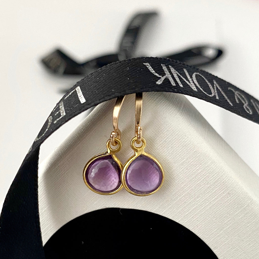 Leoni & Vonk amethyst and gold fill earrings photographed on a white box with Leoni & Vonk ribbon