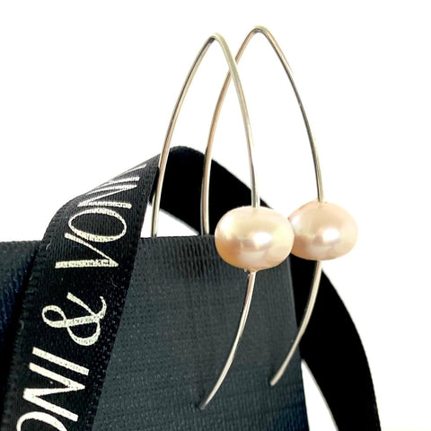 Leoni & Vonk sterling silver and pink pearl earrings with a black box and Leoni & Vonk ribbon