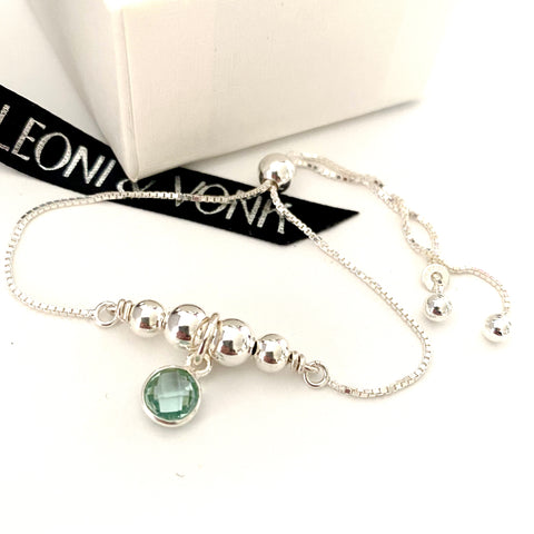 Leoni & Vonk aquamarine sterling silver bracelet photographed near a white box and Leoni & Vonk ribbon