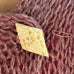 Leoni & Vonk vintage carved bone brooch on a pink knit