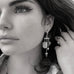 Cropped black and white image of a dark haired girl wearing Leoni & Vonk earrings