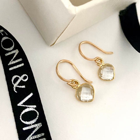 Leoni & Vonk crystal heart earrings photographed near a white box and Leoni & Vonk ribbon