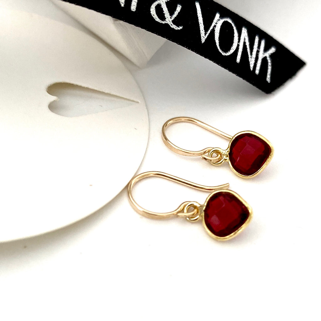 Leoni & Vonk garnet and gold heart earrings photographed near  Leoni & Vonk ribbon