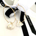 Leoni & Vonk gold hoop earrings with keshi pearls and black Leoni & Vonk ribbon