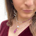 Model wearing Leoni & Vonk July ruby  and October pink opal jewellery and a red velvet top