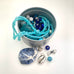 Leoni & Vonk ocean blue bead tin containing a variety of blue beads in different shapes and sizes