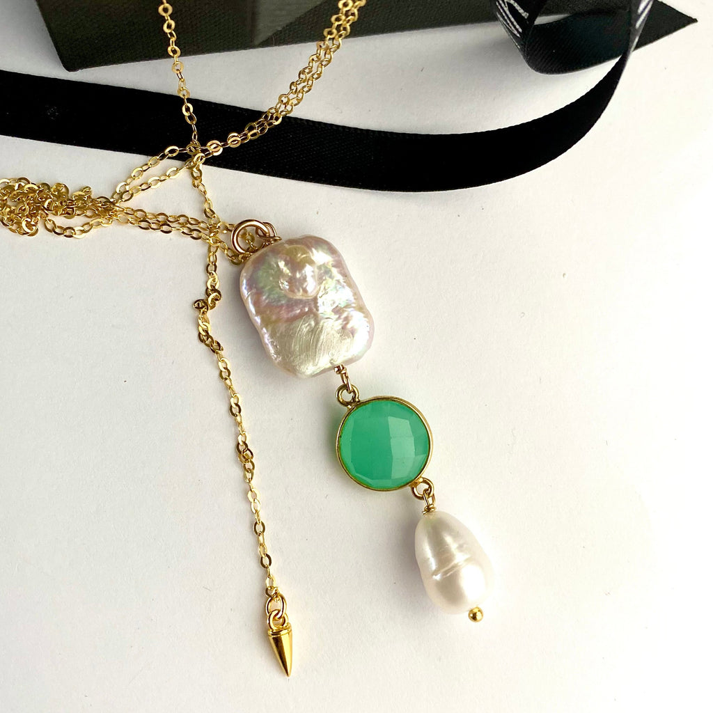 Leoni & Vonk pearl and aqua chalcedony necklace on a gold chain with black ribbon.