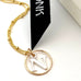 Leoni & Vonk gold and silver initial necklace with Leoni & Vonk ribbon