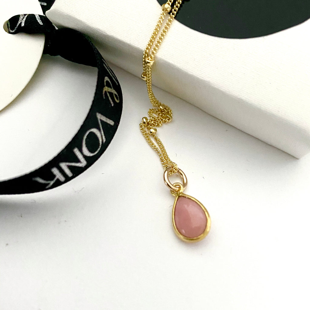 Leoni & Vonk pink opal necklace photographed near a white box and leoni & Vonk ribbon