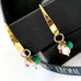 Leoni & Vonk multicoloured gemstone and pearls gold charm earrings on a black box