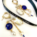 Leoni & Vonk pearl, sapphire, gold and silver chandelier  earrings on a white background and with Leoni & Vonk ribbon.