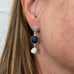 Close up image of a model wearing Leoni & Vonk Sapphire and pearl earrings