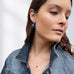 Model wearing Leoni & Vonk September sapphire jewellery and a denim jacket