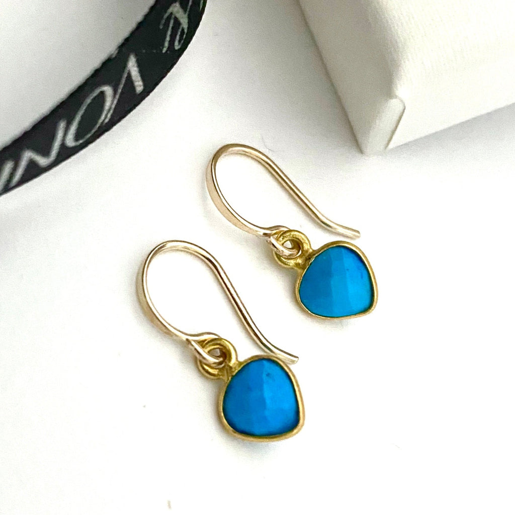 Leoni & Vonk turquoise heart december birthstone earrings photographed near a white box and Leoni & Vonk ribbon