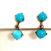 Leoni & Vonk 9ct rose gold and blue stone screw back earrings on a white background