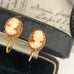 Leoni & Vonk vintage gold plated cameo earrings with screw backs on a vintage box and a vintage postcard