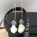 Leoni & Vonk vintage cufflink component earrings with large white baroque pearls hanging on a black box and with Leoni & Vonk ribbon